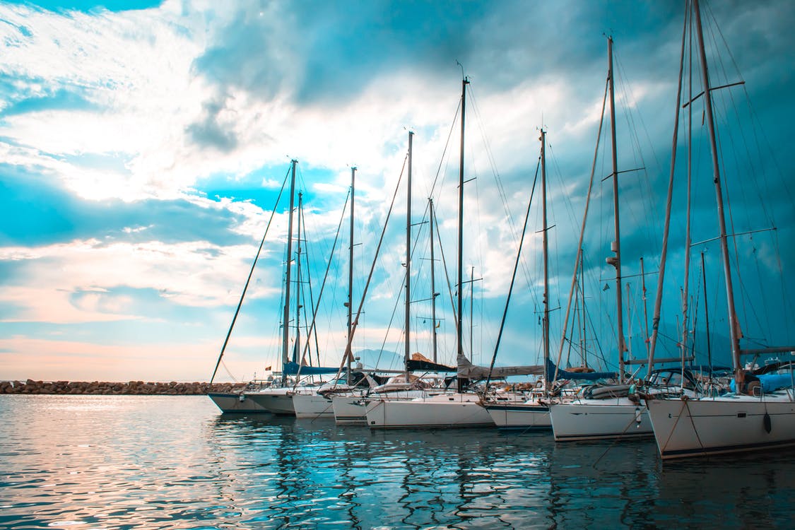 Boats moored in an Aeolian Islands marina at sunset